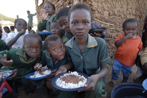 Children eating what they eat...rice and beans.