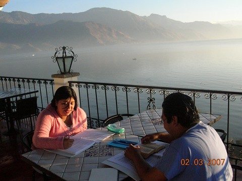Judith and Dr. Byran Saban Doing an Extension Bible Course Together Overlooking Lake Atitlan